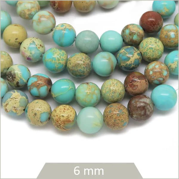 Env. 60 perles rondes Régalite teintée bleu cyan 6 mm